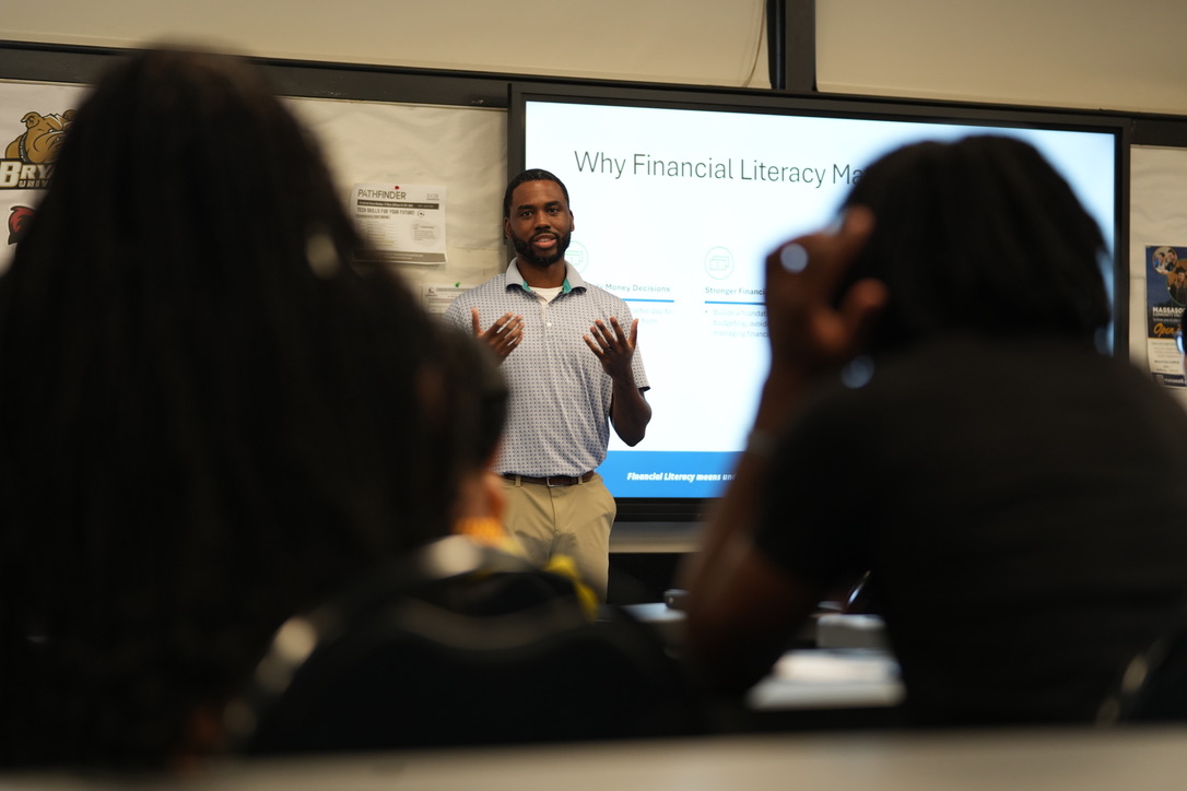 An instructor leads a financial literacy lesson for Elevation Project students